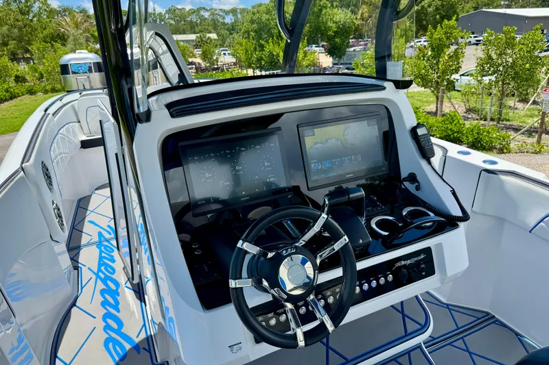 Slide: The Image of 2024 Renegade 38 Open boat dashboard with advanced navigation system and sleek steering wheel. - 22