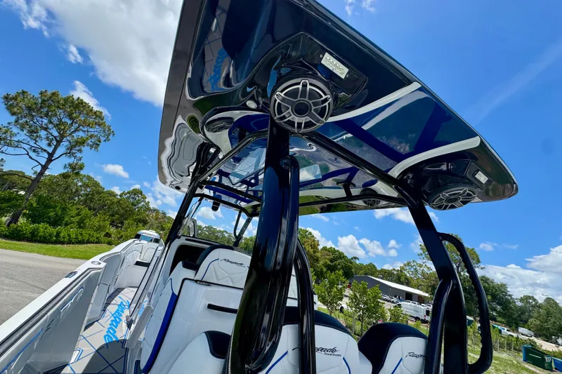 Slide: The Image of 2024 Renegade 38 Open boat with sleek design and modern features under a clear blue sky. - 25