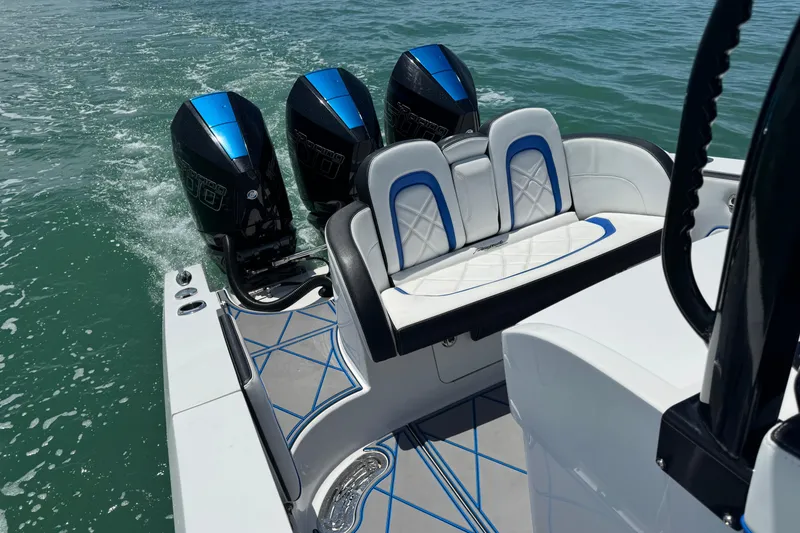 Slide: The Image of 2024 Renegade 38 Open boat with triple outboard engines on water. - 28