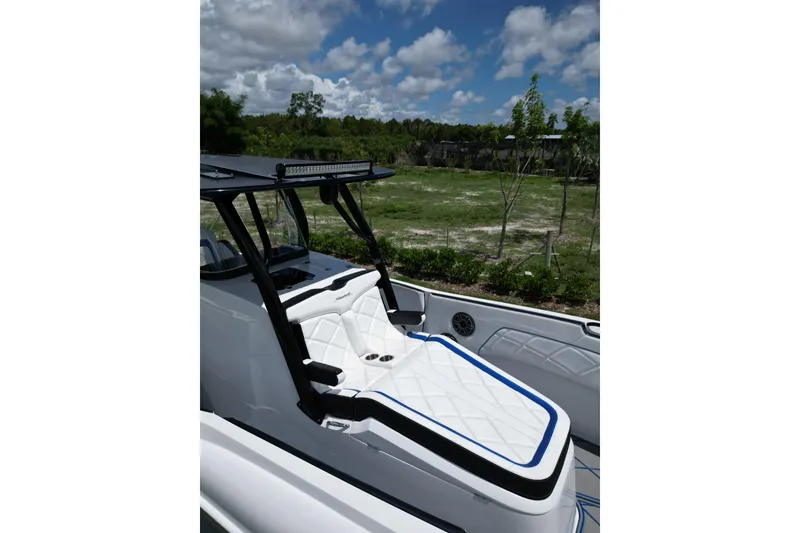 Slide: The Image of 2024 Renegade 38 Open boat with sleek seating and modern design under a blue sky. - 30