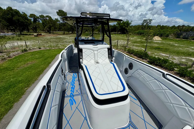 Slide: The Image of 2024 Renegade 38 Open boat with sleek white and blue interior design. - 32