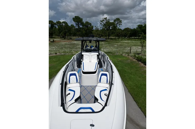 Slide: The Image of 2024 Renegade 38 Open boat with sleek seating and modern design under cloudy skies. - 33