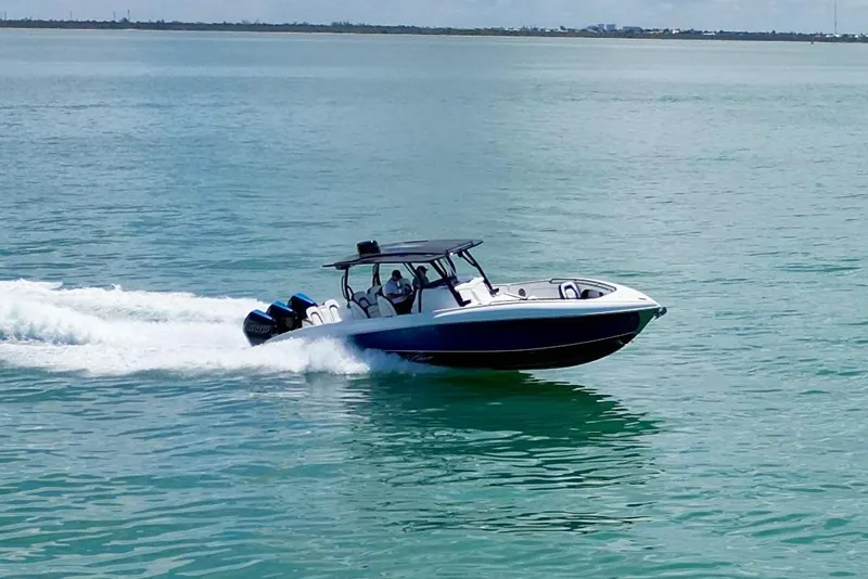 Slide: The Image of 2024 Renegade 38 Open boat cruising on clear blue water. - 4