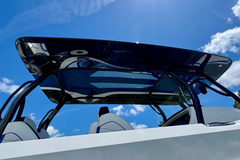 Slide: The Image of 2024 Renegade 38 Open boat with sleek canopy against a clear blue sky. - 42