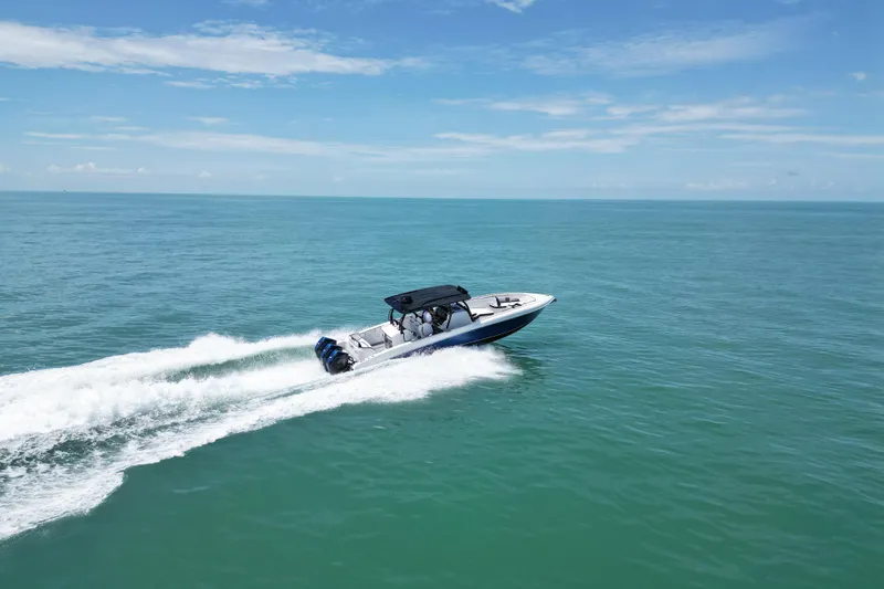 Slide: The Image of 2024 Renegade 38 Open boat cruising on open sea under clear blue sky. - 6