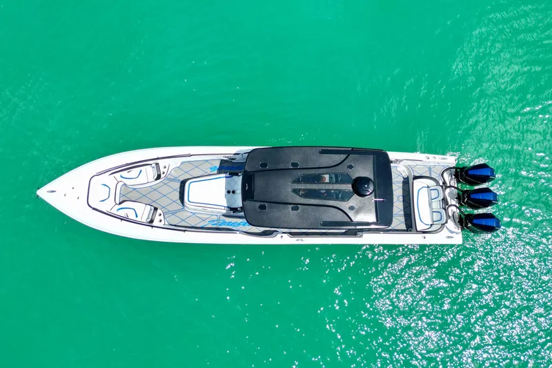 Slide: The Image of Aerial view of 2024 Renegade 38 Open boat on turquoise water. - 8