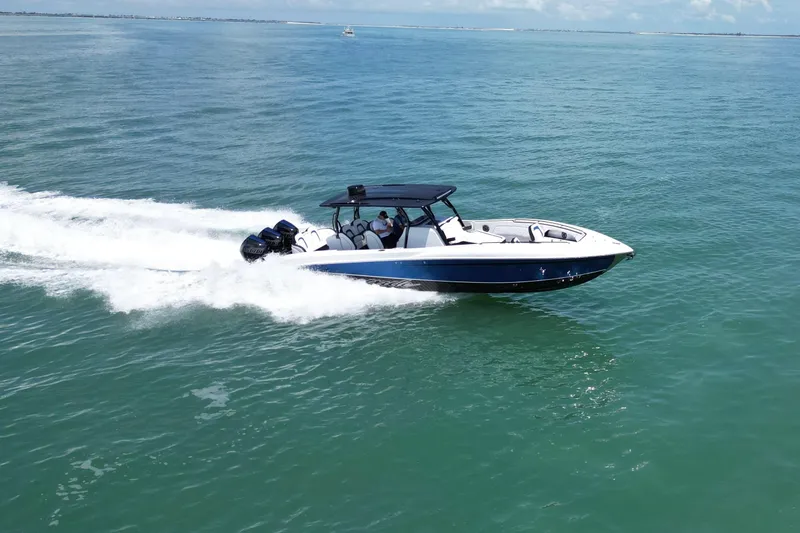 Slide: The Image of 2024 Renegade 38 Open boat cruising on clear blue ocean waters. - 9