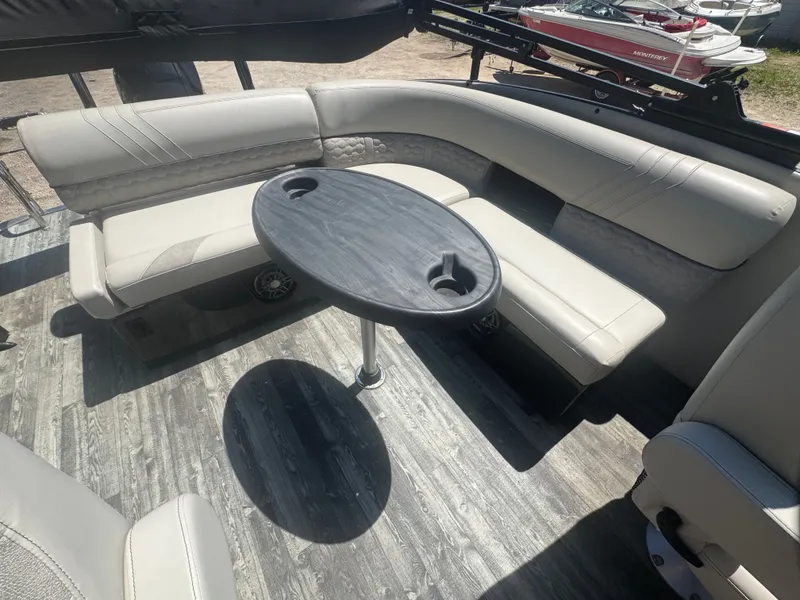 Slide: The Image of Interior of a 2020 Crest Caribbean boat with gray table and seating area. - 15