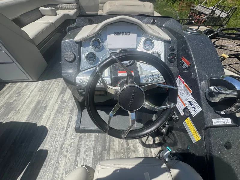 Slide: The Image of Control console of a 2020 Crest Caribbean boat with steering wheel and instruments. - 8