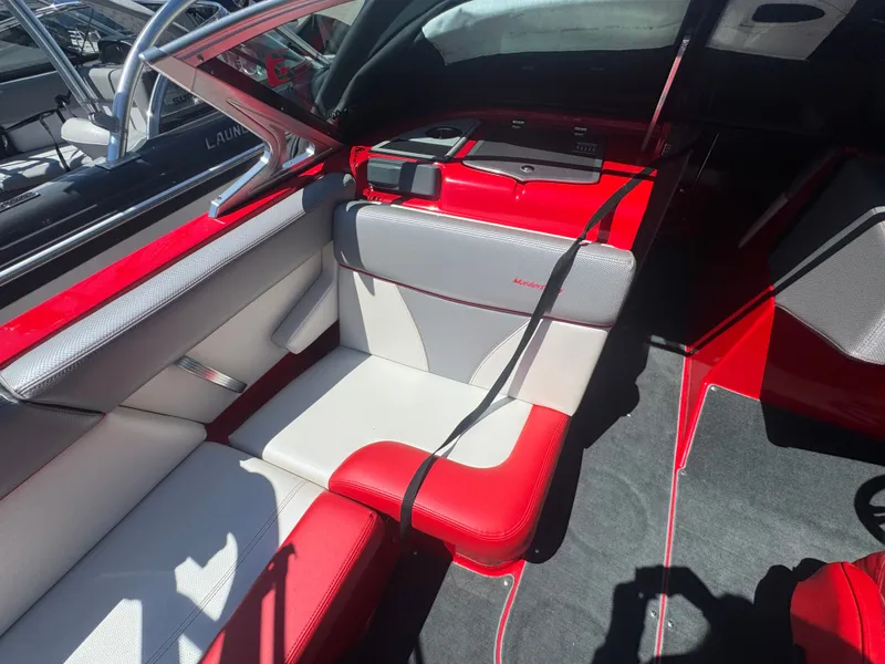 Slide: The Image of Interior of a 2017 MasterCraft XT23 boat with red and white seating. - 13