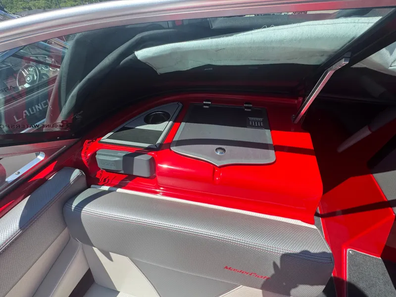 Slide: The Image of Interior of a 2017 MasterCraft XT23 boat, red and gray upholstery. - 14