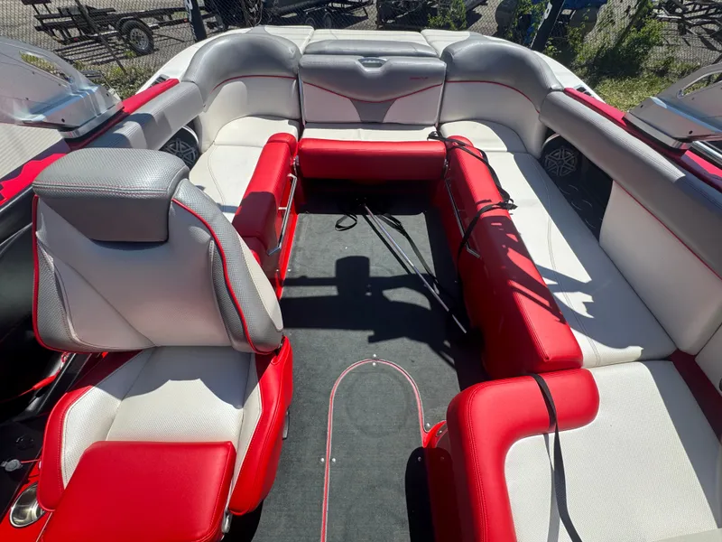 Slide: The Image of Interior of a 2017 MasterCraft XT23 boat with red and gray seating. - 18