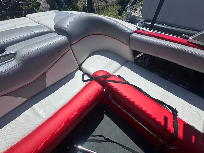 Slide: The Image of Interior of a 2017 MasterCraft XT23 with gray and red seating. - 20