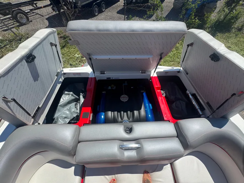 Slide: The Image of Interior view of a 2017 MasterCraft XT23 boat with open storage compartments. - 21