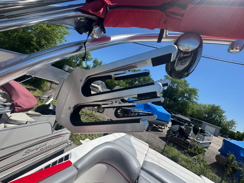 Slide: The Image of 2017 MasterCraft XT23 with wakeboard rack and red sunshade. - 8