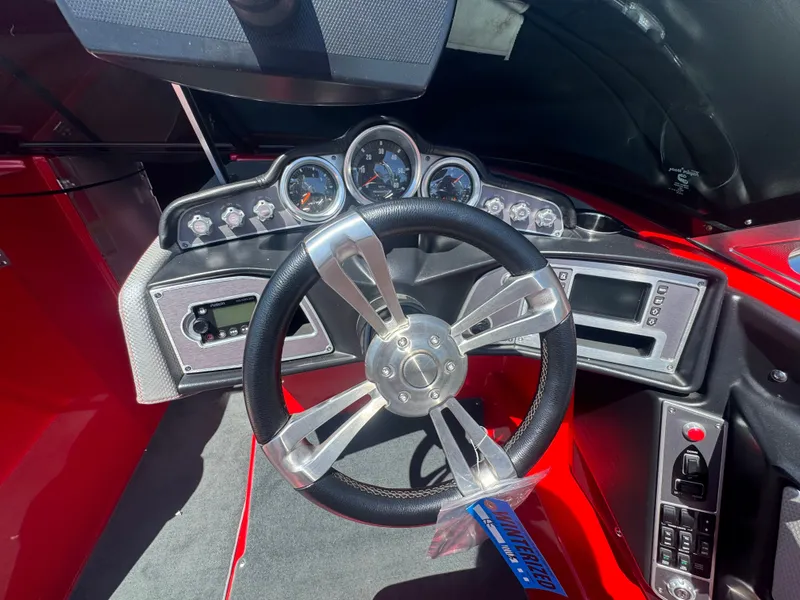 Slide: The Image of Dashboard of a 2017 MasterCraft XT23 boat with steering wheel and gauges. - 9