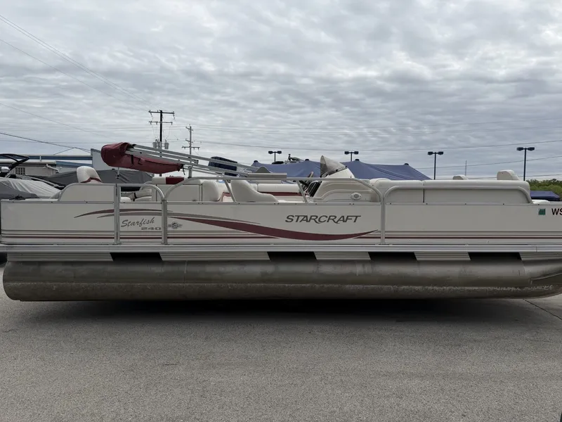 The Image of 2003 Starcraft 240 Starfish pontoon boat on parking lot. - 1