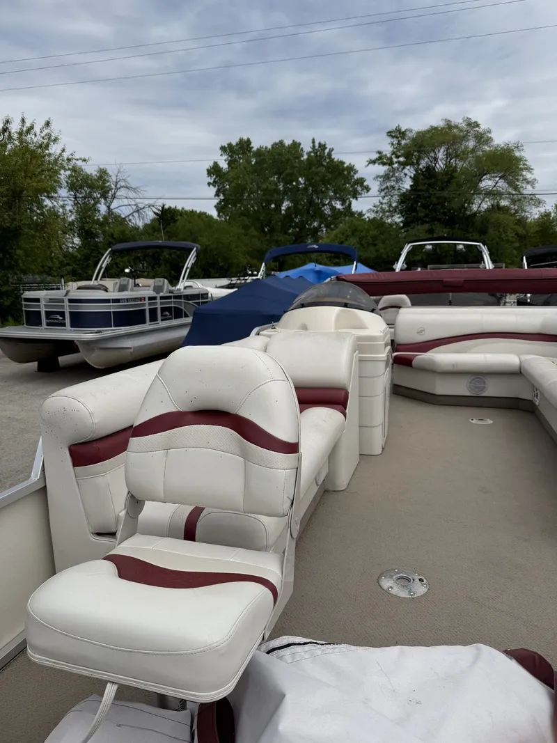 Slide: The Image of 2003 Starcraft 240 Starfish pontoon boat with white and red seating. - 5