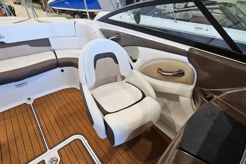 Slide: The Image of Interior of a 2021 Monterey 224FS boat with white and brown seating. - 10