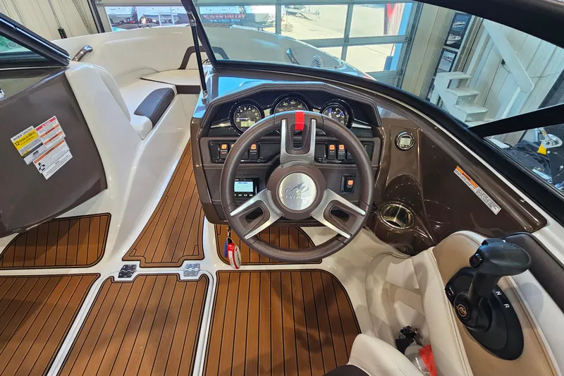 Slide: The Image of Interior view of 2021 Monterey 224FS boat cockpit with steering wheel and controls. - 13