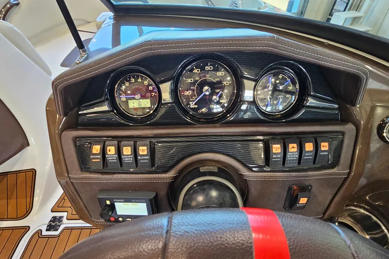 Slide: The Image of Dashboard of a 2021 Monterey 224FS boat with gauges and control switches. - 14