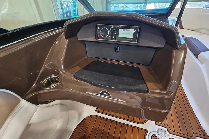 Slide: The Image of Dashboard of a 2021 Monterey 224FS boat with audio system and wood accents. - 15