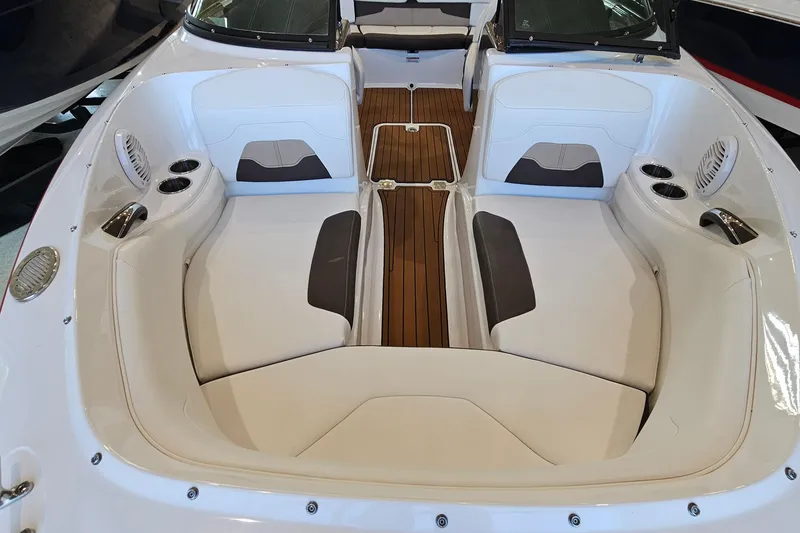 Slide: The Image of 2021 Monterey 224FS boat interior with white seating and wood flooring. - 17