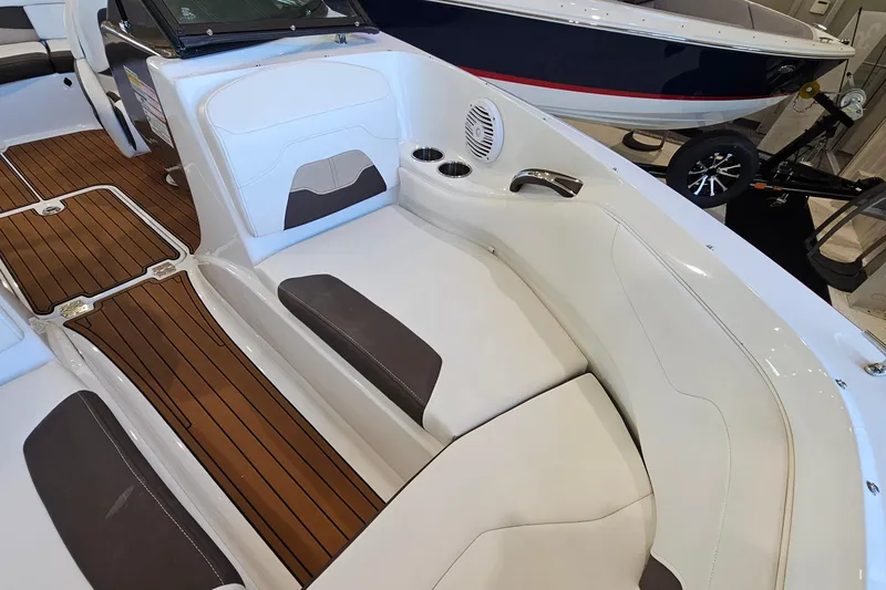 Slide: The Image of 2021 Monterey 224FS boat interior with white seating and wood-style flooring. - 18