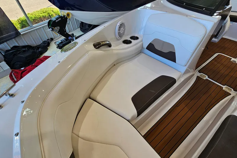 Slide: The Image of Interior of a 2021 Monterey 224FS boat with white seating and wood flooring. - 19