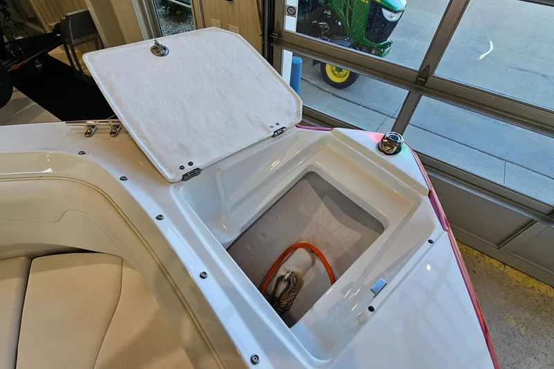 Slide: The Image of 2021 Monterey 224FS boat with open storage compartment in a garage setting. - 20