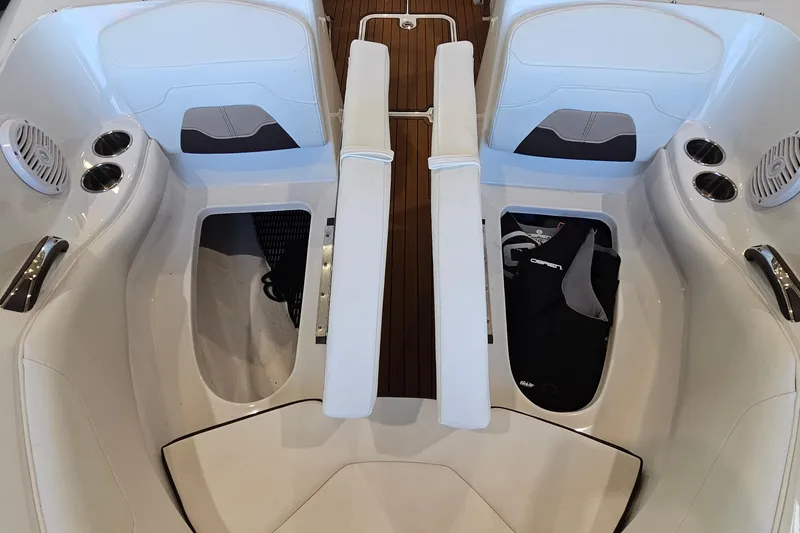 Slide: The Image of Interior view of 2021 Monterey 224FS boat, featuring white seating and cup holders. - 21