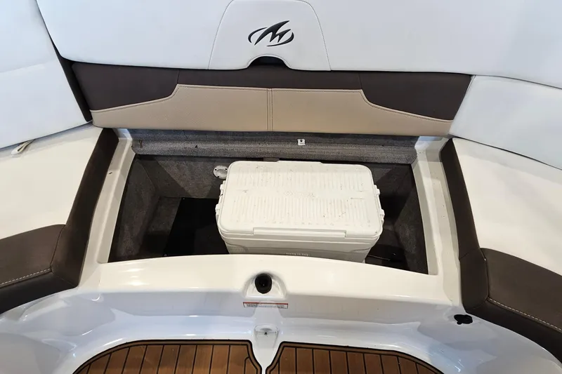 Slide: The Image of 2021 Monterey 224FS boat storage compartment with cooler, featuring sleek seating design. - 23
