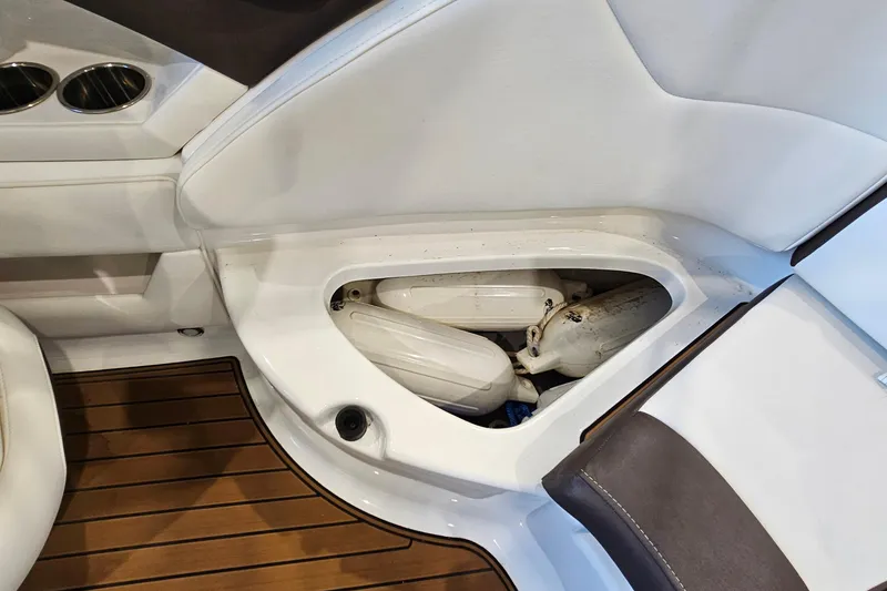 Slide: The Image of Storage compartment on a 2021 Monterey 224FS boat with fenders and cup holders. - 25