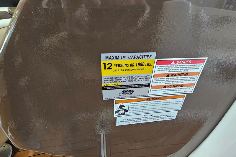 Slide: The Image of 2021 Monterey 224FS boat capacity label, maximum 12 persons or 1980 lbs, safety warnings included. - 28