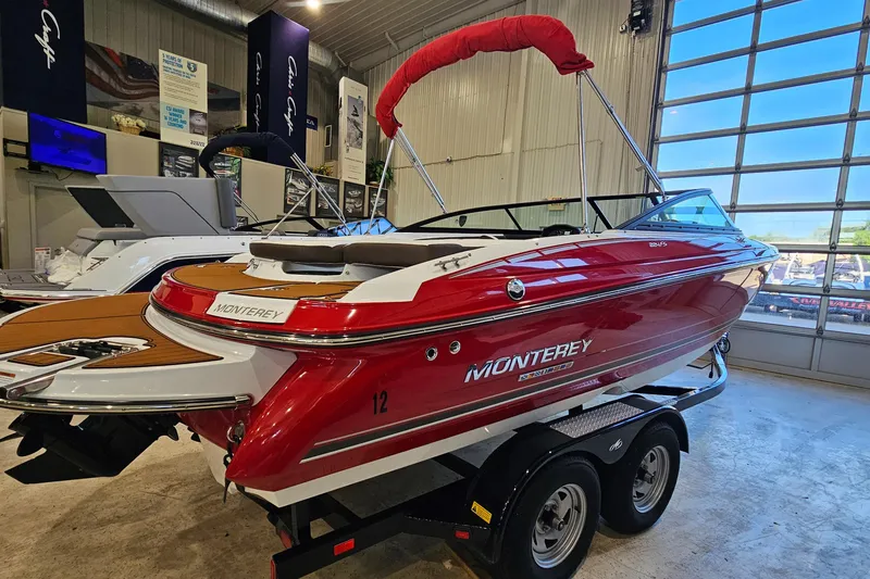 Slide: The Image of Red 2021 Monterey 224FS boat on trailer in showroom, featuring sleek design and vibrant color. - 3