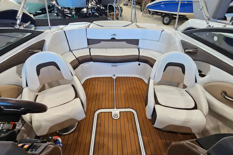 Slide: The Image of Interior of a 2021 Monterey 224FS boat with stylish seating and wood flooring. - 7