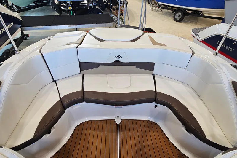 Slide: The Image of 2021 Monterey 224FS boat interior with cushioned seating and teak flooring. - 8
