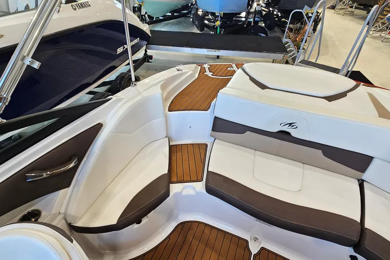 Slide: The Image of 2021 Monterey 224FS boat interior with stylish seating and teak flooring. - 9