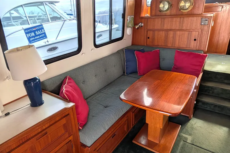 Slide: The Image of Cozy interior of 2001 Nordic Tug 37 with green sofa and wooden table. - 19