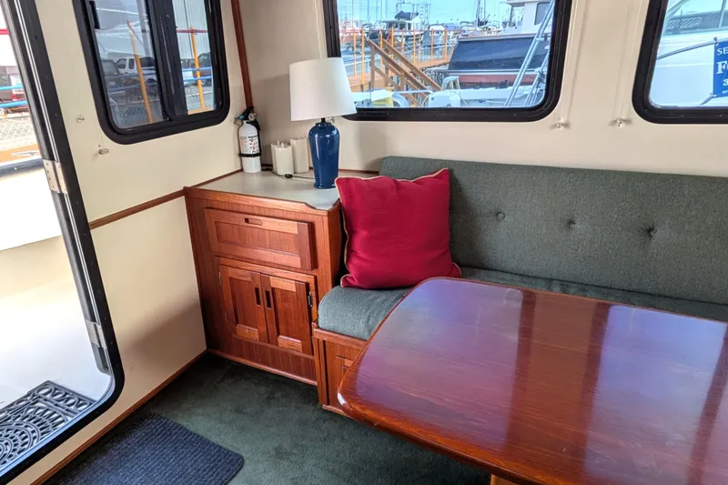 Slide: The Image of Interior of a 2001 Nordic Tug 37 with a computer workstation and large windows. - 23