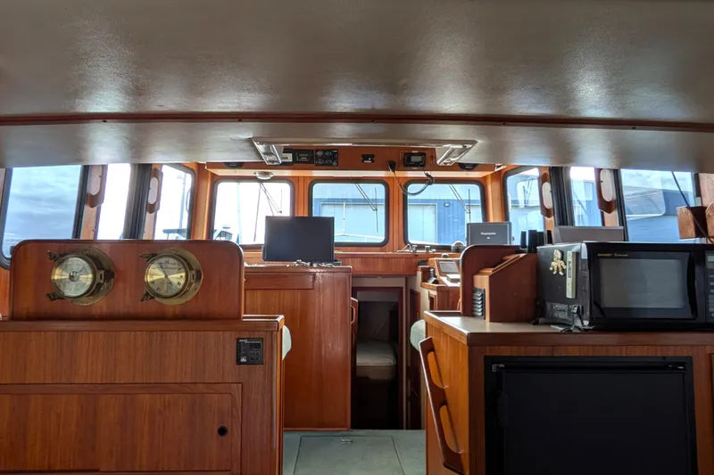 Slide: The Image of Control panel of a 2001 Nordic Tug 37 with navigation and speed instruments. - 28