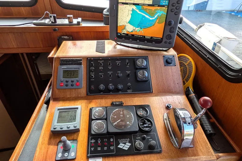 Slide: The Image of Pilot house of a 2001 Nordic Tug 37 with navigation equipment and controls. - 33