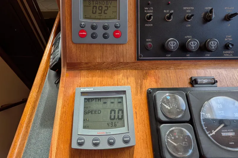 Slide: The Image of Cozy cabin bedroom in a 2001 Nordic Tug 37 boat, featuring wooden cabinetry and a neatly made bed. - 35