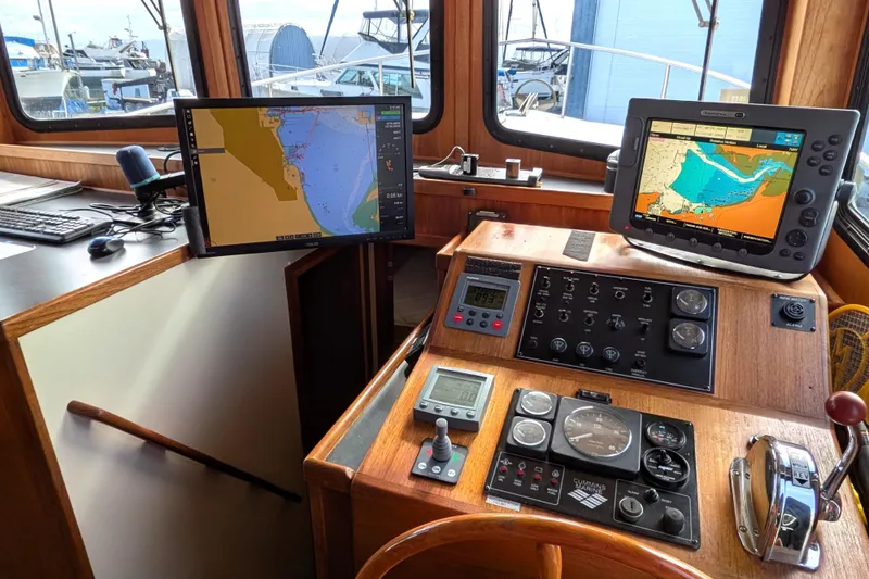 Slide: The Image of Bathroom interior of a 2001 Nordic Tug 37, featuring a shower, sink, and toilet. - 40