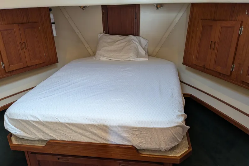Slide: The Image of Bathroom interior of a 2001 Nordic Tug 37, featuring a sink, shower, and wooden cabinetry. - 42
