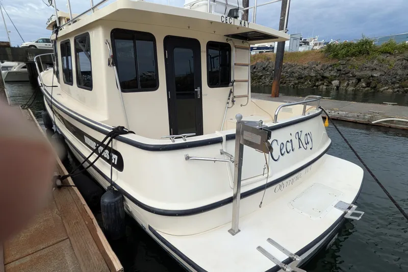 Slide: The Image of 2001 Nordic Tug 37 docked, rear view with "Ceci Kay" name visible. - 8