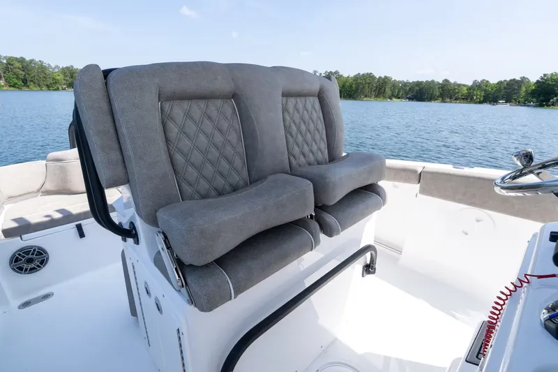 Slide: The Image of 2027 Sea Hunt Ultra 255 SE boat seats on calm water. - 10