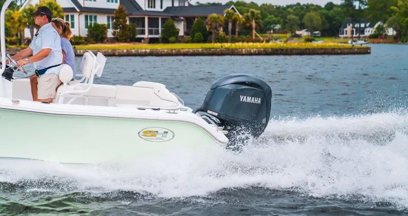 Slide: The Image of 2027 Sea Hunt Ultra 219 boat on water with Yamaha engine. - 19