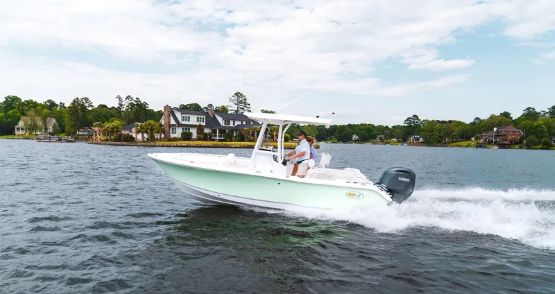 Slide: The Image of Sea Hunt Ultra 219 boat on a lake, 2027 model. - 2