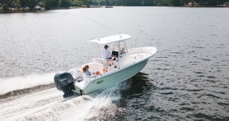 Slide: The Image of 2027 Sea Hunt Ultra 219 boat cruising on a lake. - 3
